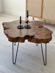 a wooden table with two candles on it