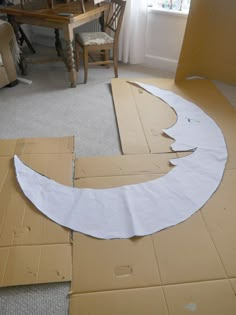 the cardboard moon is cut out and placed on the floor