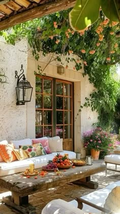 an outdoor living area with couches and tables