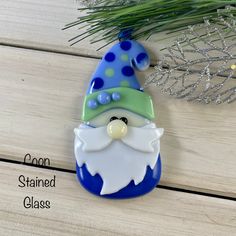 a glass ornament with a gnome face on it