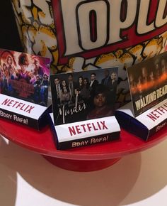 there are many movies on the red trays that have been placed in front of each other