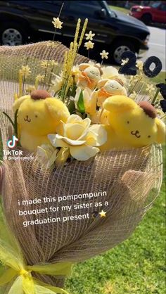 a bunch of yellow stuffed animals sitting in a bouquet on top of a grass field