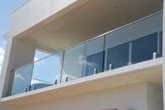 a balcony with glass balconies and railings on the side of a building