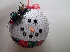 a snowman ornament hanging on a wall