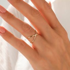 The Plain X Ring is made with a genuine design so that you could wear it with confidence in any environment you wish to be present. Its particular design will make you look more elegant than usual and induce all the eyes around you to stare at your minimalist beauty. - Made in 14k solid gold - Band Width: 1.07 mm / 0.04 inches - Ring Width: 8.00 mm / 0.31 inches - Thickness: 1.20 mm / 0.04 inches - This product comes with iconic Norm Jewels gift box Plain Gold Ring, X Ring, Criss Cross Ring, Double Band Rings, Crossover Ring, Luxury Jewelry Brands, Solid Gold Band, Gold Ring Stack, Rose Gold Band