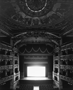 an empty theater with the light coming through the window