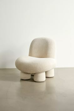 a white chair sitting on top of a cement floor