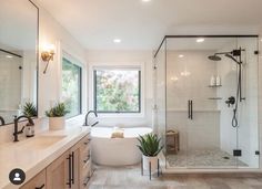 a bathroom with a tub, sink and shower