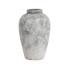 a large gray vase sitting on top of a white table