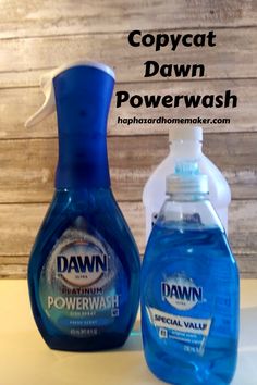 two bottles of dawn powerwash sitting next to each other on top of a table