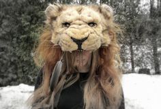 a woman wearing a lion mask in the snow