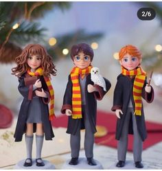 three figurines of harry potter and hermione's hogwarts