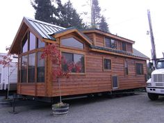 a truck is parked next to a tiny house