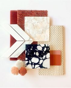 an arrangement of different materials on a white surface with red and orange accents, including a piece of paper