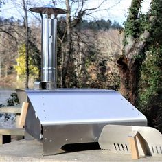 an outdoor bbq grill sitting on top of a cement slab