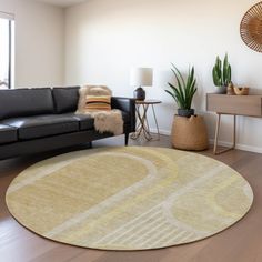 a living room with a black couch and white rug