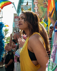 a woman in a yellow top standing next to some people