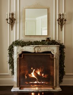 a fire place with a mirror above it