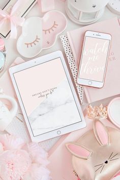 an assortment of pink and gold items on a table