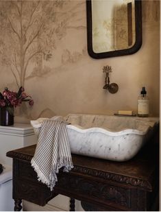 a white sink sitting on top of a wooden counter