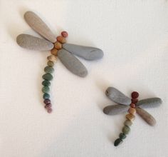 three dragonflys made out of stones and beads