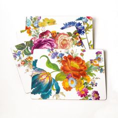 three coasters with colorful flowers and peacocks on them, one has a white background