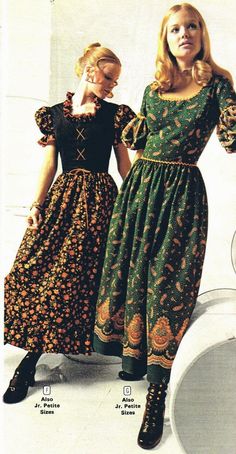 two women in dresses standing next to each other