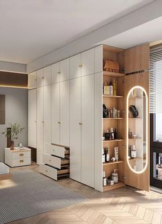 a bedroom with white furniture and wooden flooring next to a large mirror on the wall