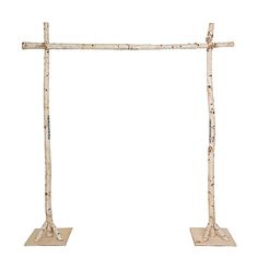 two wooden crosses are standing next to each other on metal bases, one is made out of birch and the other is painted white