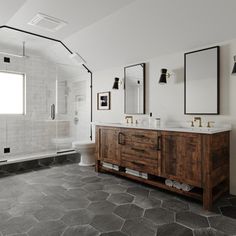 a large bathroom with two sinks and mirrors