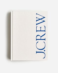 a book with blue lettering on it sitting on top of a white table next to a wall