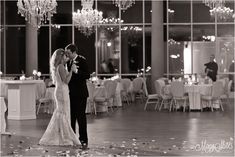 a bride and groom share their first dance at their wedding reception in the grand ballroom