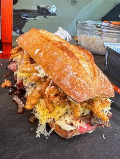 a large sandwich sitting on top of a cutting board