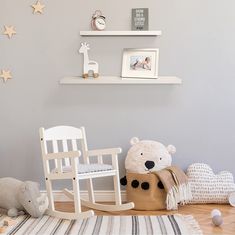 a baby's room with rocking chair, teddy bear and other toys