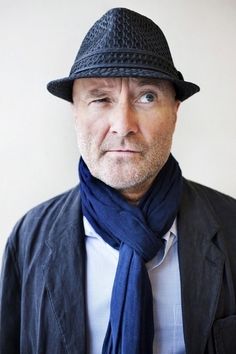 a man wearing a black hat and blue scarf