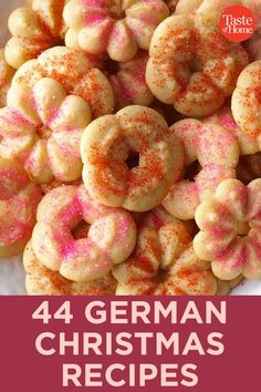 a white plate topped with donuts covered in pink sprinkles and text that reads, 44 german christmas recipes