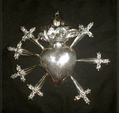 a silver plate with crosses and a heart on it