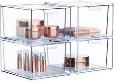 three clear containers with different types of cosmetic items in them and one container containing lipstick