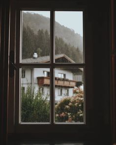 an open window with the view of a house in the background