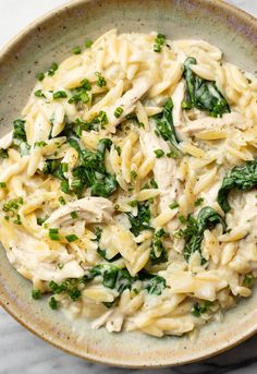 pasta with chicken and spinach in a bowl