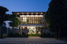 a modern house is lit up at night