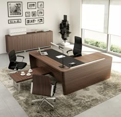 an office desk with two chairs and a table