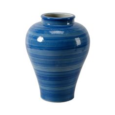 a large blue vase sitting on top of a white table