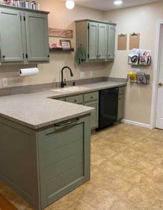 a kitchen with green cabinets and an island