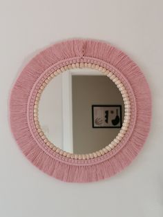 a round mirror hanging on the wall