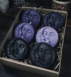 six soaps in a box with faces on them