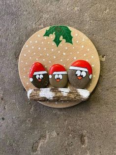 three birds are sitting on a branch decorated with christmas decorations