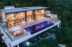 an aerial view of a modern house with pool