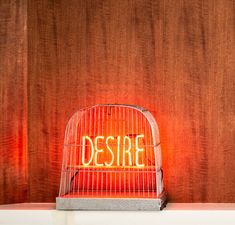 a birdcage with the word desire written on it