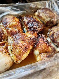 several pieces of chicken sitting on top of tin foil covered in powdered sugar and seasoning